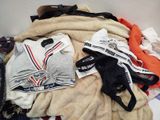 a pile of clothes that is on a table