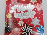 a close up of a book on a table with cookies and candies