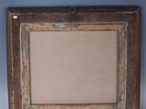 an old wooden picture frame with a beige linen backing