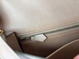 a person holding a white purse with a zipper