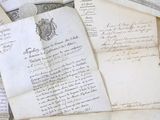 a pile of old letters and papers on a table
