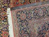 two rugs with different colors and patterns are on the floor