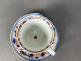 an overhead view of a cup and saucer on a table