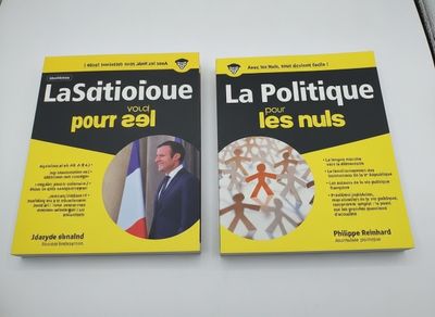 two books sitting on top of a white table next to each other