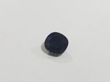 a blue sapphire stone sitting on top of a white surface
