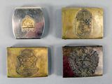four silver and gold metal business cards with emblems on them