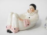 a figurine of a woman sitting in a bathtub next to a dog