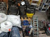 many different types of tools on a pallet in a warehouse