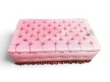 an image of a pink ottoman on a white background