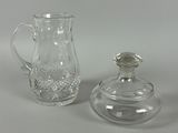 two glass vases and a glass bottle on a table