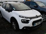 a white citrole parked in a parking lot next to other cars