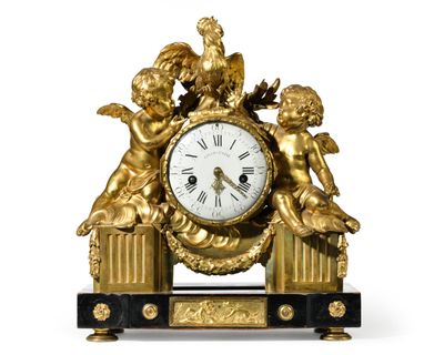 a gold clock with cherensils and angels on it