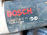 a close up of a bosch power tool on a pile of other tools