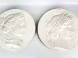 two roman coins, one of which has a head of a woman and one of which is a head of