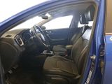 the interior of a blue car with the door open and the driver ' s seat down