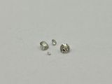 a pair of diamond earrings sitting on top of a white surface