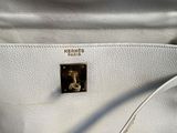 the inside of a white purse with a zipper on it