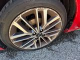 a red car that has a flat tire on it