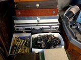 a drawer full of books and other items on a table