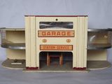a small toy garage with shelves and shelves on the side