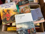 many books in a box that are sitting on the floor
