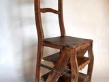 a wooden chair that has a ladder on it