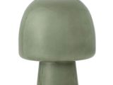 une lampe verte posée sur une table blanche