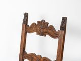 an old wooden chair with a carved back and seat on a white background