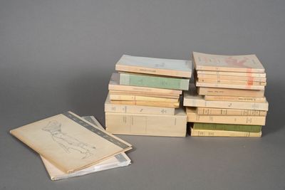 several books stacked on top of each other on a table