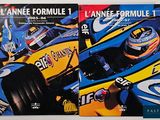 two books on a table with a picture of a racing car