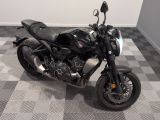 a black motorcycle that is parked on a checkered floor