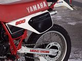 a red and white motorcycle parked in a garage