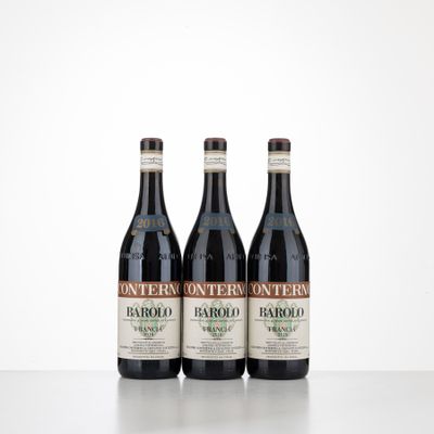 three bottles of wine sitting on top of a table next to each other