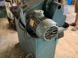 a man standing next to a machine in a workshop