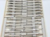 a lot of pens in a case on a table
