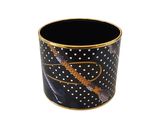 a black and gold cup with a design on it