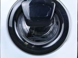 a close up of a white washing machine with a black knob