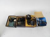 a box with a camera, a camera case, and other items in it