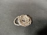 a silver chain that is laying on top of a table