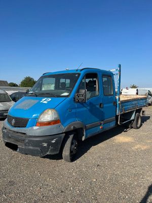 a blue truck that is parked in the parking lot