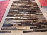 un tapis constitué de bandes de bois posé sur le sol