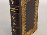 an old book sitting on top of a table with a white background
