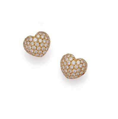 a pair of diamond heart earrings