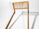 a wooden bed frame with a wooden headboard and foot board