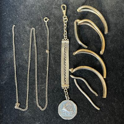 several pieces of jewelry are displayed on a black surface
