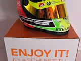 a helmet on top of a box that says enjoy it it ' s a schuberth