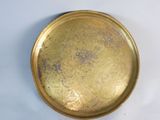 a gold plate that is sitting on a white table