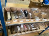 many boxes of electronic equipment on a shelf in a warehouse
