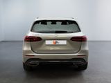 the rear end of a silver mercedes suv parked in a white room