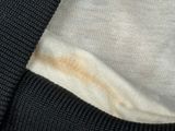 a close up of a sweater with a stain on the back of it